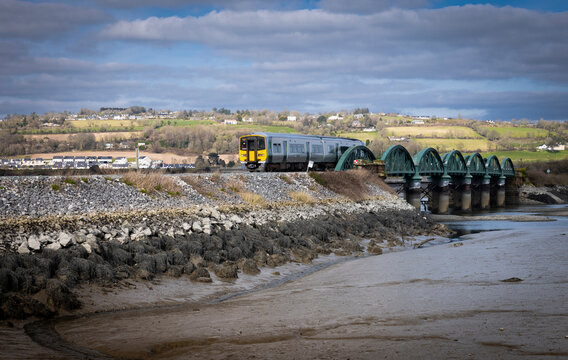 Fota, Ireland  - March 6th 2025 - Iarnrod Eireann Irish Rail DMU Diesel Multiple Unit train crossing viaduct over Slatty Water to Fota Island
