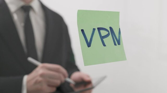 Businessman Moves VPN Sticker Across Office Glass