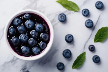 Delicious blueberries in a white bowl paired with sweet blueberry jam on a stylish grey background, perfect for culinary and food photography enthusiasts