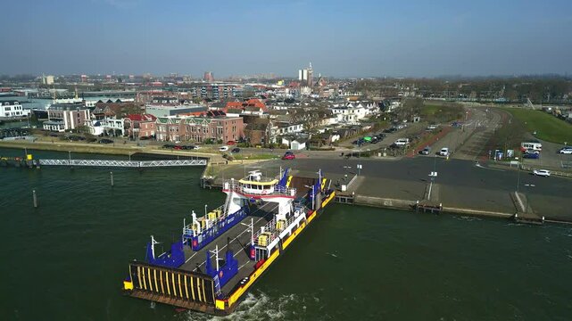 view of ferry arrived the port of Maassluis, vehicles going out of it on a sunny day in Netherlands
