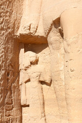 Smaller statues beside the standing colossal Ramses and Nefertari statues are their children at entrance of the Temple of Nefertari, Egypt
