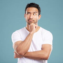 Man, thinking and idea in studio for decision, planning and problem solving on blue background....