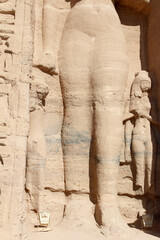 Smaller statues beside the standing colossal Ramses and Nefertari statues are their children at...