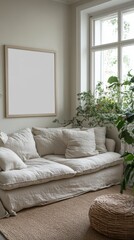 Beige linen sofa with plush cushions, a large empty picture frame, and potted plants in a sunlit room. Natural light illuminates the calming interior.