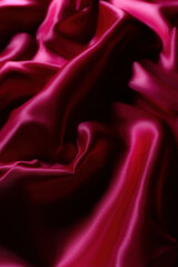 Luxurious silky fabric in deep magenta with elegant folds and soft lighting. Perfect for fashion design, textile backgrounds, branding, digital art, beauty aesthetics, romantic themes