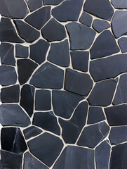 Dark gray irregular stone mosaic wall texture