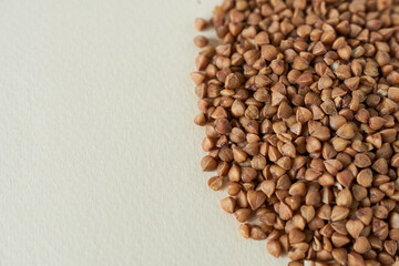 Buckwheat groats on a light background. Close-up.