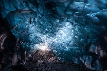 Naturally formed blue ice cave with bubbles in Vatnajokull glacier national park