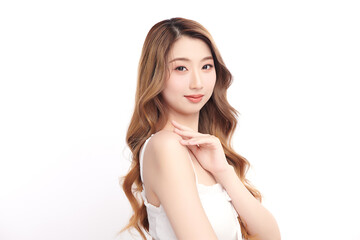 Obraz premium A beautiful young Asian woman with clean, fresh skin against a white background. She represents beauty, skincare, and spa treatments.
