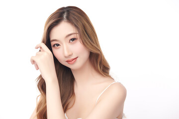 Obraz premium A beautiful young Asian woman with clean, fresh skin against a white background. She represents beauty, skincare, and spa treatments.