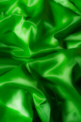 Vibrant green silky fabric with smooth folds and glossy texture. Ideal for luxury fashion, textile design, branding, nature-inspired themes, digital art, and eco-friendly product backgrounds