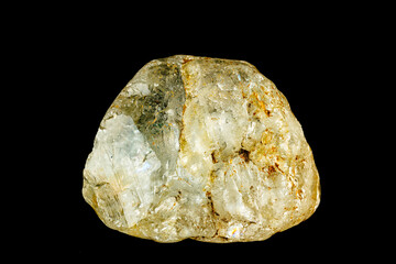 Raw topaz mineral specimen with a translucent surface and natural textures on a black background.