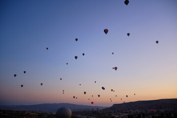 Hot air balloons flying during sunrise in valley. Sunrise at Cappadocia. Goreme, Nevsehir, Cappadocia