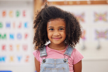 Education, portrait and smile of girl student in classroom for development, growth or learning. Child, knowledge and scholarship with happy kid learner at school for academy course or Montessori