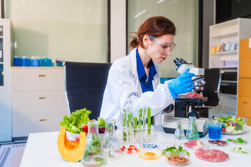 Middle-aged female laboratory worker wearing blue gloves conducts lab test on food ingredients...