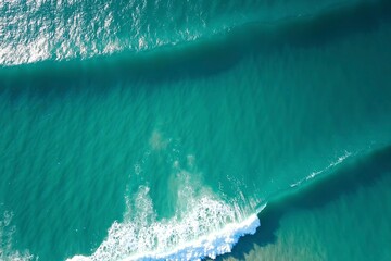Turquoise ocean waves from above, a serene seascape of calm and beauty.