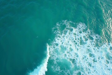 Turquoise ocean waves from above, a serene seascape of calm and beauty.