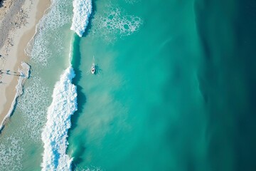 Turquoise ocean waves from above, a serene seascape of calm and beauty.