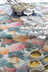 White cups with chopped fresh fruit and a spoon. Blue glass plate and colorful tablecloth with hydrangea flowers, appetizer, healthy, food, snack