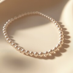 Obraz premium Elegant Pearl Necklace Displayed on Soft Neutral Background