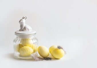 Top view of Easter eggs painted with yellow paint. White background. Copy space.