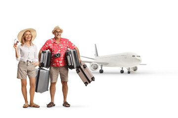 Female tourist with her husband carrying many suitcases at the airport