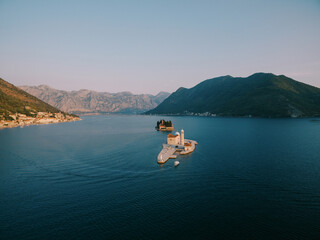 Boat sails along the Bay of Kotor to the island of Gospa od Skrpjela. Montenegro