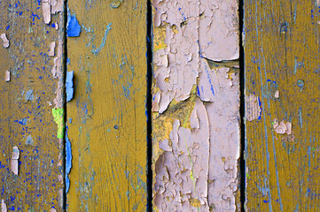 Peeling brown and purple paint on old weathered wood - texture background