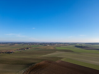 Obraz premium Lier, Antwerp, Belgium, March 5th, 2025, An aerial view captures a stunningly beautiful landscape featuring vibrant green fields beneath a clear blue sky