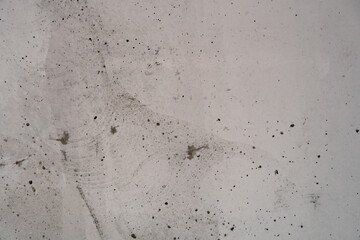 Abstract close-up of raw concrete wall with rough imperfections and surface details