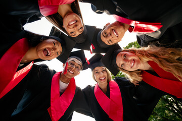 Low ange view photo of groupmates students have good mood mortarboard gown graduate college outdoors