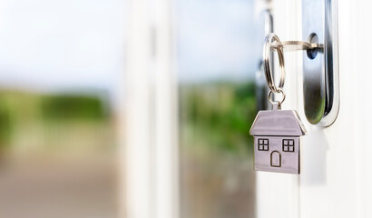 House key on keychain in a door background