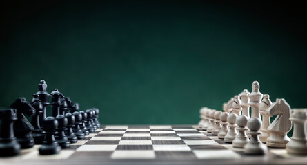 Chess pieces on chess board at begining of game, competition, planning and strategy background