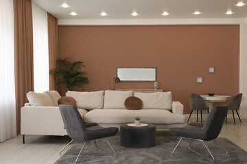 Stylish living room with elements in mocha mousse shade. Interior design with trendy color of 2025 year