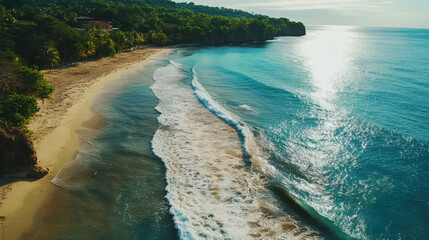 Waves softly crash onto the sandy shore as the sun sets, casting a warm glow over the tranquil beach surrounded by vibrant greenery and clear blue waters