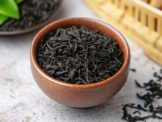 Tea set with black tea and fresh green leaves
