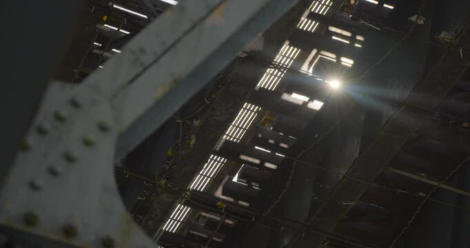 Sunburst Coming Through Tracks of Elevated Subway in NYC