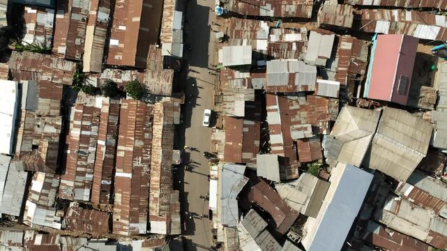 Aerial view of crowded rooftops in Kibera Slum with rustic tin roofs and dense urban landscape, Nairobi, Nairobi, Kenya.