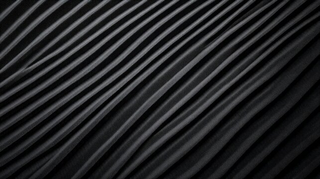 A close-up view of textured black fabric with parallel lines, creating a wave-like pattern that adds depth and visual interest.
