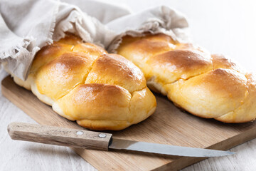 Traditional Easter braided bread. Tsoureki braid on white wooden table