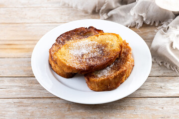 Traditional Spanish torrijas for Holy Week on wooden table. French Toast