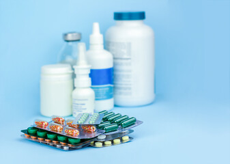 Various capsules, pills, spray on a blue. Pharmaceutical medicament