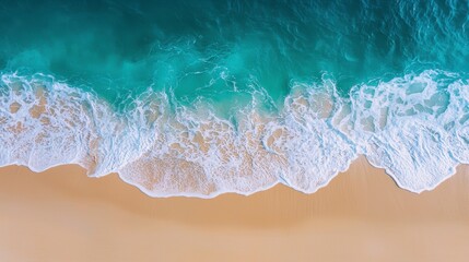 Obraz premium Gentle Waves Washing onto a Smooth Sandy Beach at Sunrise