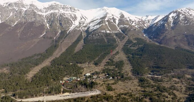 Aerial view of Fonte Cerreto, a small tourist resort located near Gran Sasso, in Abruzzo, Italy. There is snow on the top of the mountains on this sunny winter day.