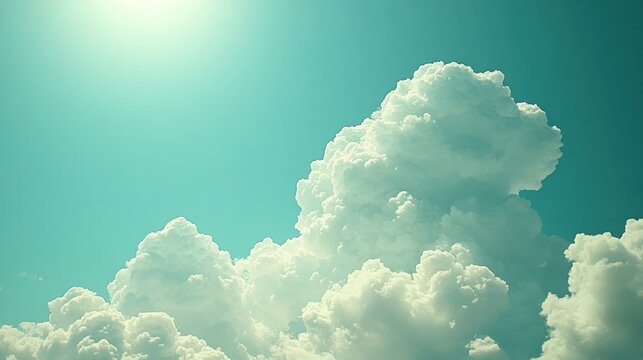 Cumulus clouds against a vibrant teal sky