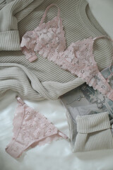 Woman's silk erotic lingerie on the white bed sheets. Valentine's day concept. Lace sexy female underwear. Beauty, fashion blogger concept. Female bra, panties, erotic clothes. Lingerie advertising