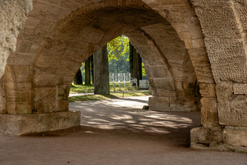 Exploring the tranquil pathways of the Great Catherine Palaces serene gardens and arches in late afternoon light