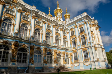 Explore the intricate architecture of Catherine Palace with its stunning golden domes and ornate decorations against a clear blue sky