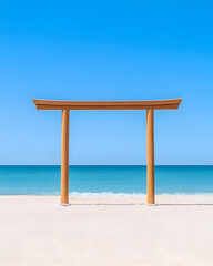 Wooden torii gate on sandy beach under blue sky