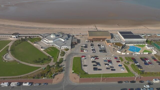 High above the Marine Hall Fleetwood and Fitness centres by the sea, with car parks and road. Lancashire, UK.
